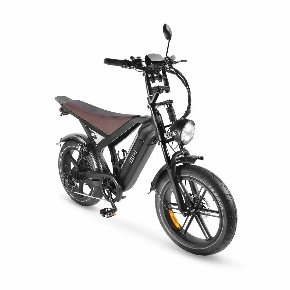 Fatbike Ouxi GT20 negra, vista frontal en diagonal con el faro redondo encendido y la pantalla en el manillar
